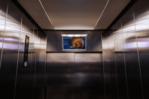 elevator advertising Dubai, lift ads UAE, elevator marketing, digital lift ads, OOH advertising Dubai, indoor advertising UAE, Essalan elevator ads