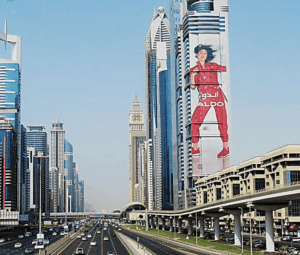 Massive building wrap advertising for ALDO displayed on a skyscraper along Sheikh Zayed Road in Dubai