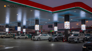 Column-mounted digital advertising screens at an ENOC gas station in Dubai, showcasing high-impact transit media campaigns.