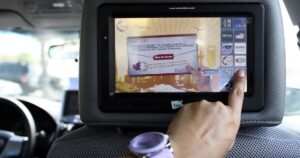 Interactive in-car taxi digital screen advertising display targeting passengers inside a Dubai cab