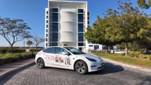 Premium electric Tesla vehicle wrap for corporate RAK taxi advertising campaigns in Ras Al Khaimah UAE