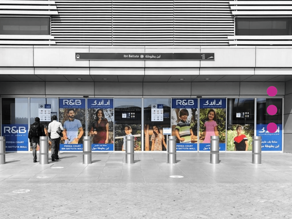 Exterior branding and transit advertising display for R&B at the Ibn Battuta Dubai Metro station entrance.