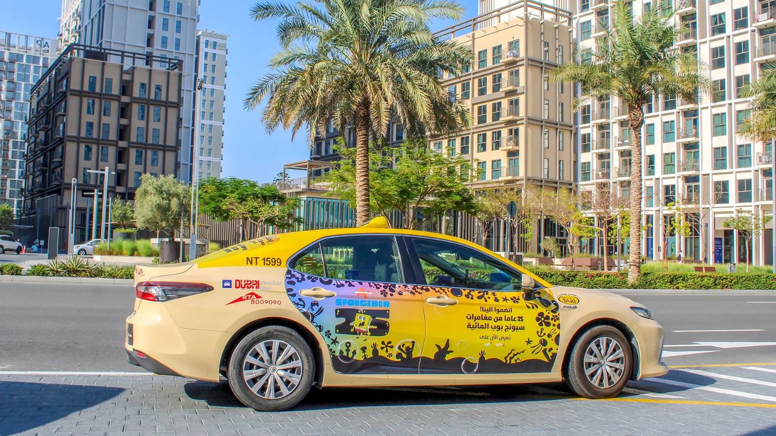 Full side door wrap branding campaign for an entertainment brand on a Dubai RTA taxi cab