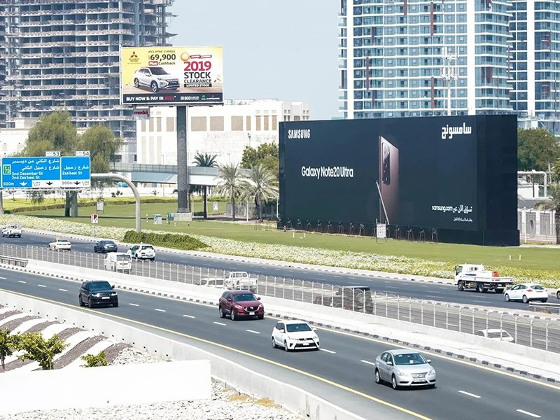 Static billboards for Samsung and Mitsubishi along a busy Dubai highway