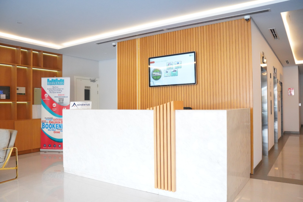 Premium digital advertising screen mounted in a modern corporate reception and elevator lobby in Dubai UAE