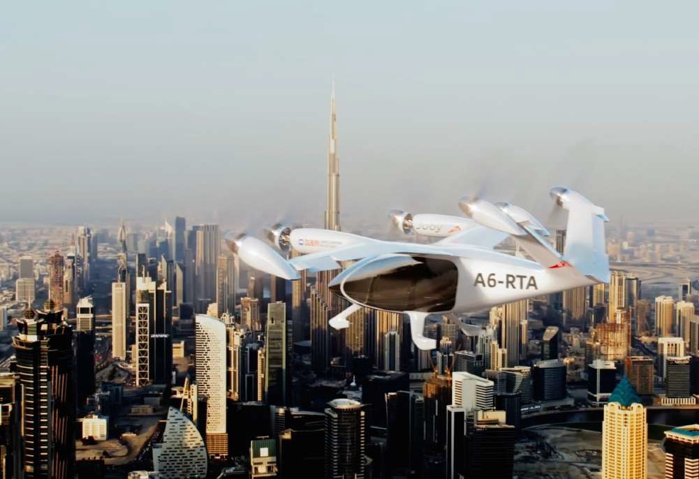 Joby Aviation electric air taxi (eVTOL) flying over the Dubai skyline with Burj Khalifa in the background