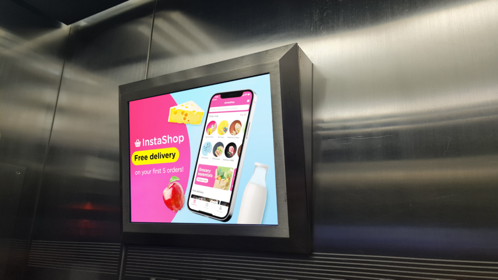 InstaShop app advertisement on digital elevator screen