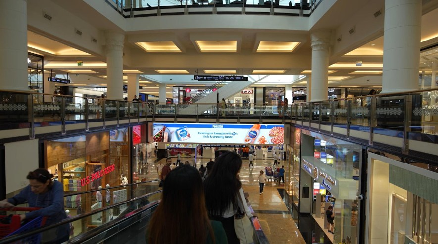 High-impact indoor digital media installation for premium retail branding within a busy shopping mall environment