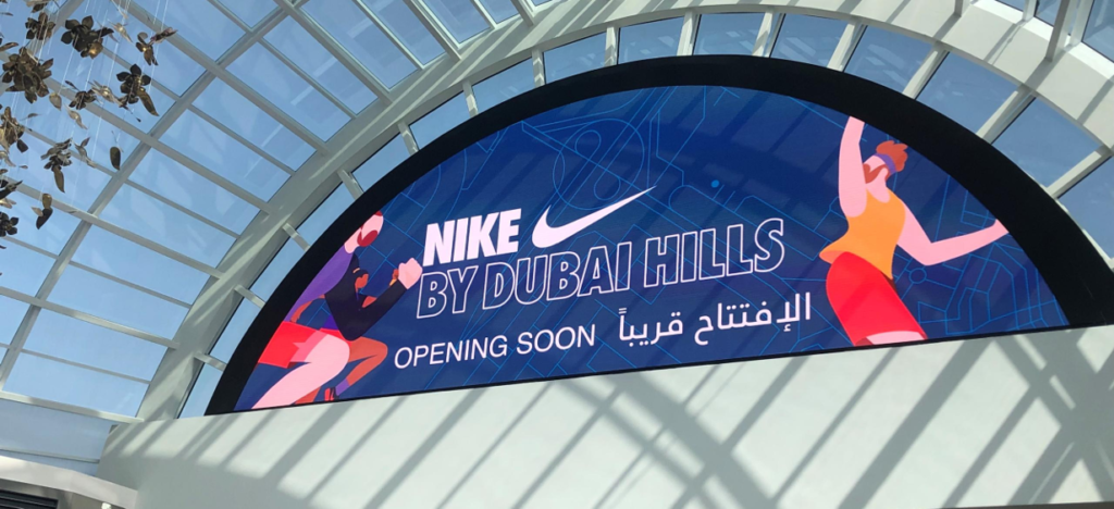 Nike 'Opening Soon' campaign on a semi-circular indoor digital display at Dubai Hills Mall