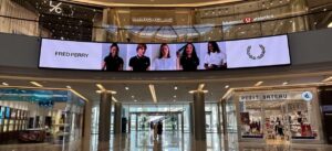 Panoramic indoor digital advertising screen displaying Fred Perry brand content at Dubai Marina Mall