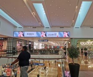Horizontal digital advertising screen displaying a KIKO Milano beauty campaign inside a luxury Dubai shopping mall